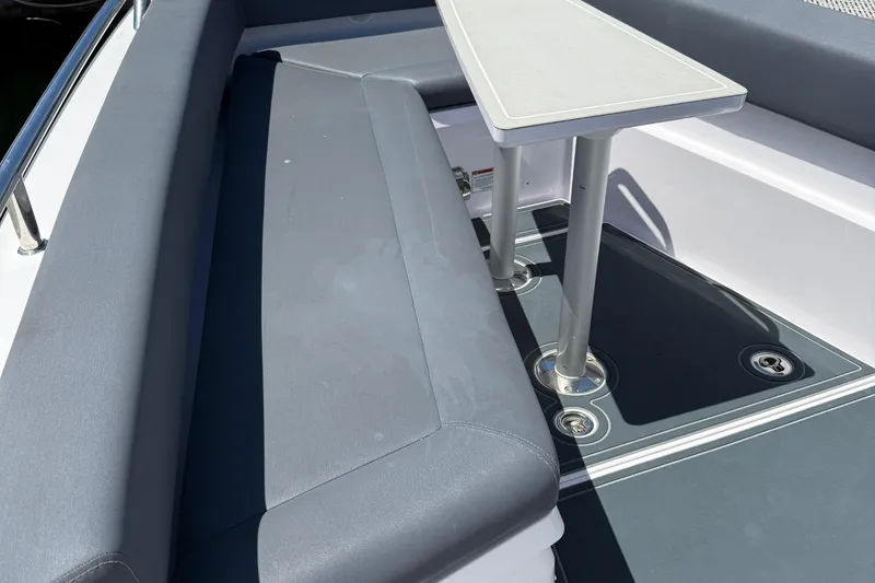 Slide: The Image of 2021 Axopar 28 WetBar boat docked at marina, featuring sleek design and spacious seating. - 7