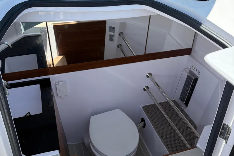 Slide: The Image of 2021 Axopar 28 WetBar boat interior with seating and table setup. - 8