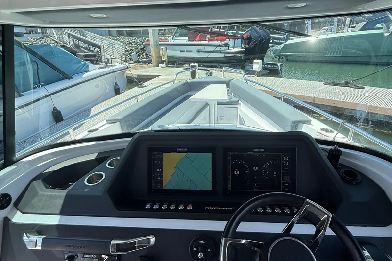 Slide: The Image of 2021 Axopar 28 WetBar boat interior with compact bathroom and modern fixtures. - 9