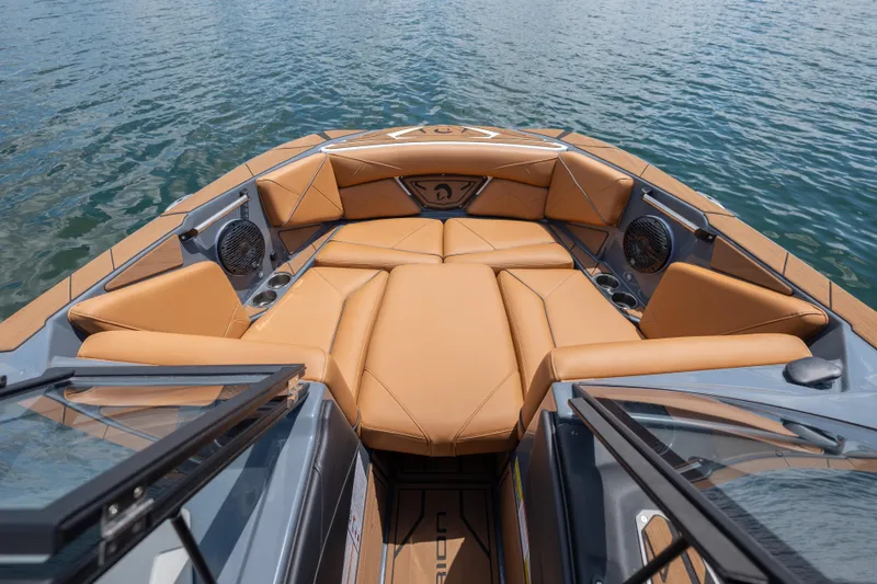 Slide: The Image of Luxurious interior of 2025 Centurion Nv233 boat with tan leather seating on water. - 11