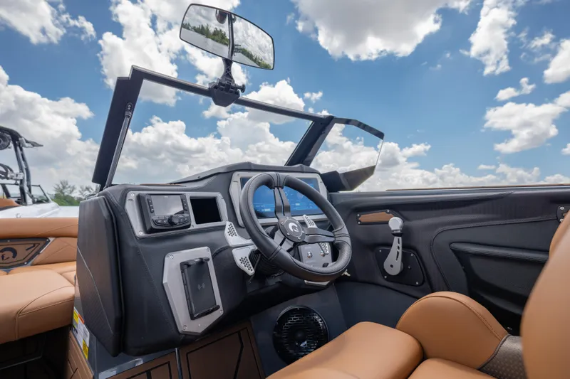 Slide: The Image of Interior of 2025 Centurion Nv233 boat with modern dashboard and steering wheel. - 13