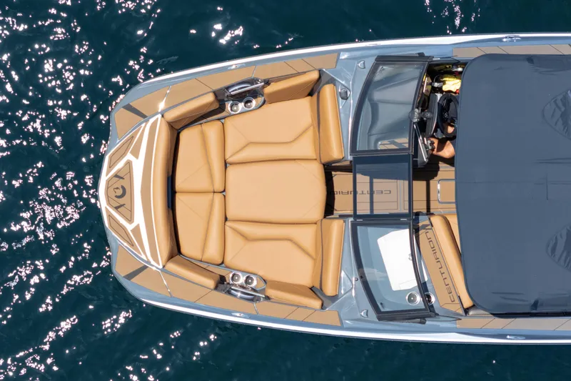 Slide: The Image of Overhead view of 2025 Centurion Nv233 boat with tan seating on water. - 22