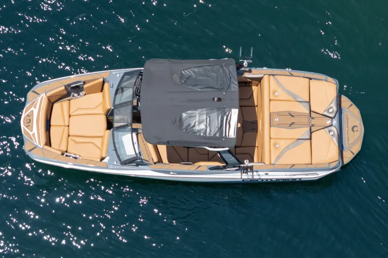 Slide: The Image of Aerial view of 2025 Centurion Nv233 boat with tan seating on blue water. - 26