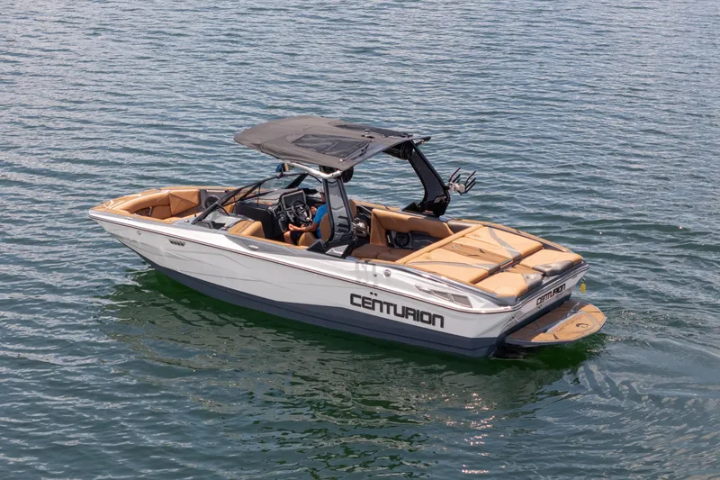 Slide: The Image of 2025 Centurion Nv233 boat on water, featuring sleek design and tan interior. - 30