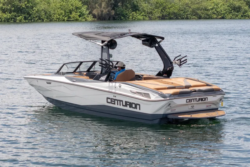 Slide: The Image of 2025 Centurion Nv233 boat on calm water, featuring sleek design and modern amenities. - 31