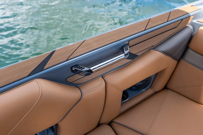 Slide: The Image of Luxurious interior of 2025 Centurion Nv233 boat with tan leather seating by water. - 6