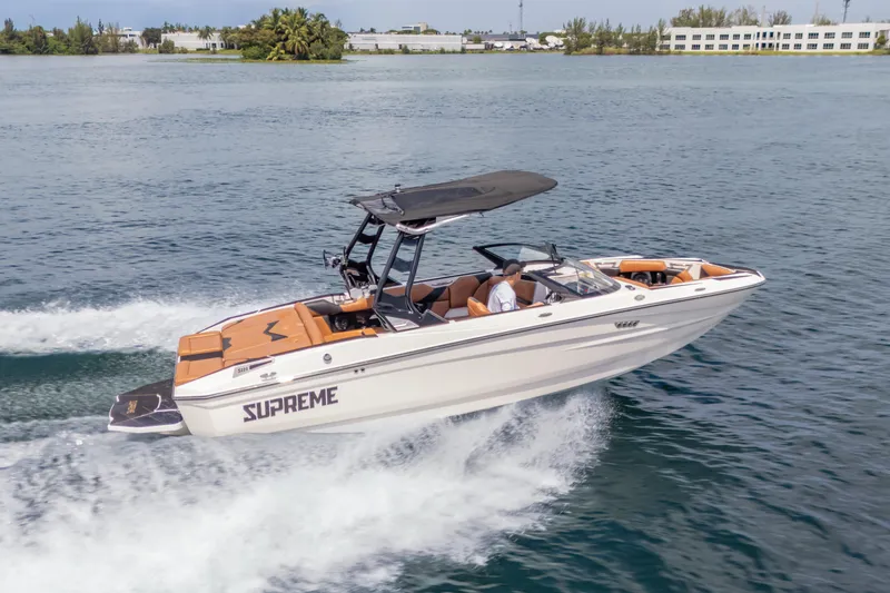 Slide: The Image of 2025 Supreme S220 boat cruising on open water, showcasing sleek design and performance. - 26