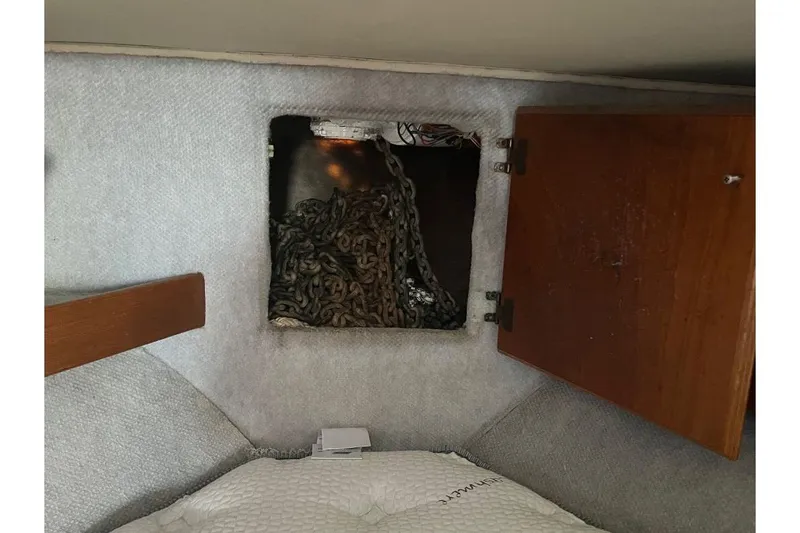 Slide: The Image of 1973 Uniflite Sport Fisher interior with open storage compartment and chain. - 102