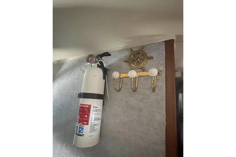 Slide: The Image of Fire extinguisher and nautical hooks inside 1973 Uniflite Sport Fisher boat. - 108