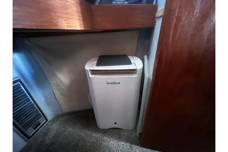 Slide: The Image of Ivation appliance inside 1973 Uniflite Sport Fisher boat cabin, with wood and carpeted interior. - 110