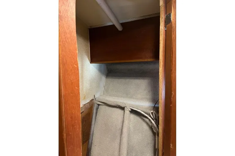 Slide: The Image of 1973 Uniflite Sport Fisher interior cabin with wooden paneling and storage space. - 111