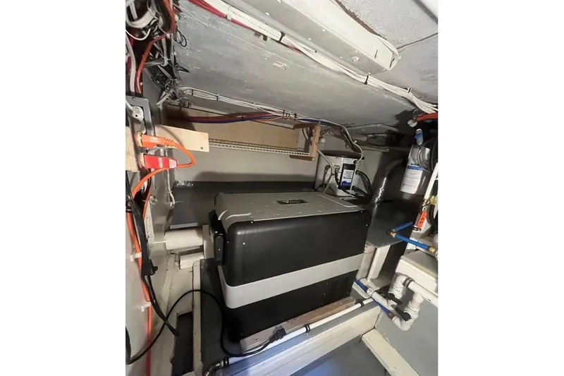 Slide: The Image of 1973 Uniflite Sport Fisher engine room with electrical wiring and equipment. - 117