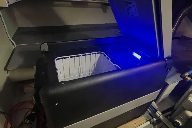 Slide: The Image of Open cooler with blue light inside a 1973 Uniflite Sport Fisher boat. - 118