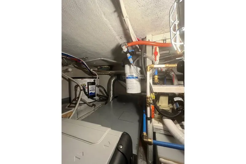 Slide: The Image of 1973 Uniflite Sport Fisher engine room with plumbing and filtration system. - 119