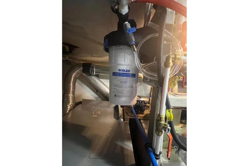 Slide: The Image of 1973 Uniflite Sport Fisher engine room with Ecolab water filter system. - 121