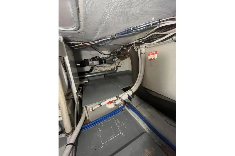 Slide: The Image of 1973 Uniflite Sport Fisher engine room with pipes and wiring. - 122