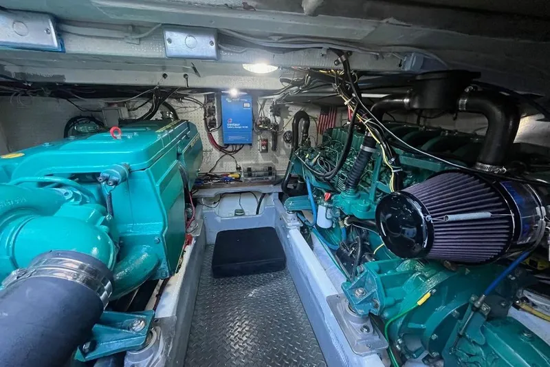 Slide: The Image of Engine room of a 1973 Uniflite Sport Fisher boat, featuring dual marine engines. - 124