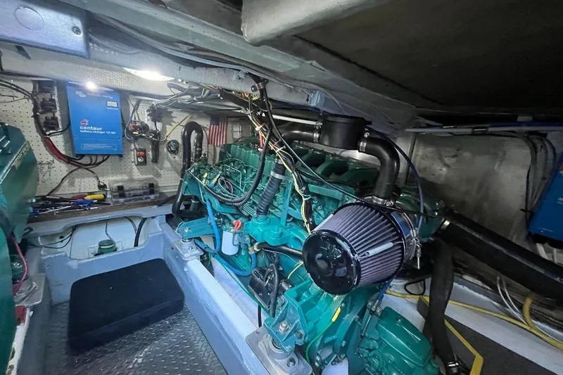 Slide: The Image of Engine room of a 1973 Uniflite Sport Fisher boat, showcasing mechanical components. - 127