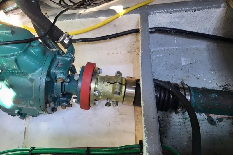 Slide: The Image of Engine compartment of a 1973 Uniflite Sport Fisher boat, showing mechanical components and hoses. - 128