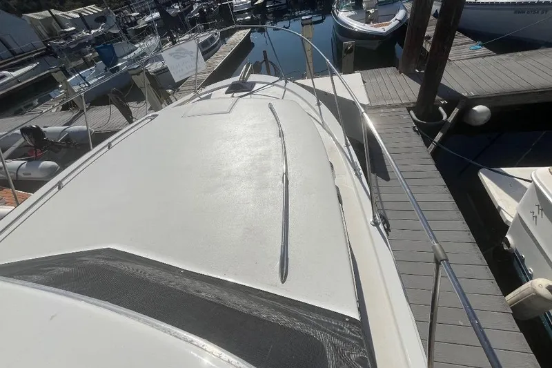Slide: The Image of 1973 Uniflite Sport Fisher boat docked at marina, view of deck and railing. - 13