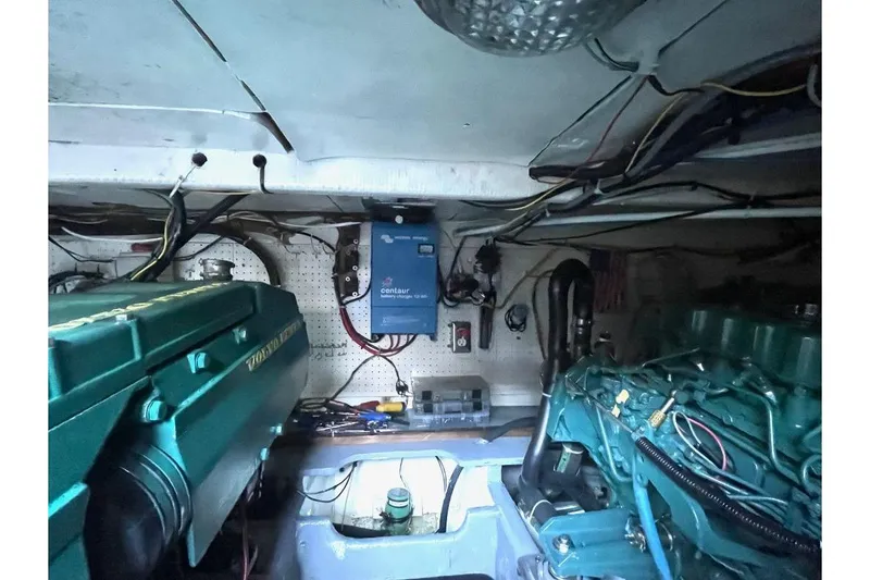 Slide: The Image of 1973 Uniflite Sport Fisher engine room with Volvo Penta engines and electrical components. - 130