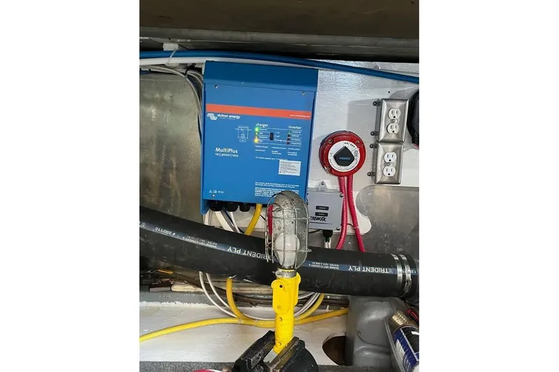 Slide: The Image of Electrical system inside a 1973 Uniflite Sport Fisher boat, featuring a Victron Energy MultiPlus inverter. - 132