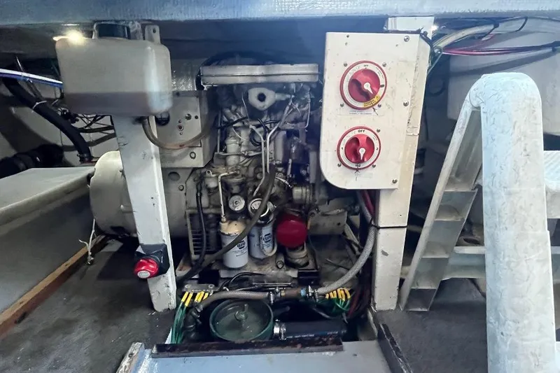 Slide: The Image of Engine compartment of a 1973 Uniflite Sport Fisher boat, showing mechanical components and controls. - 134