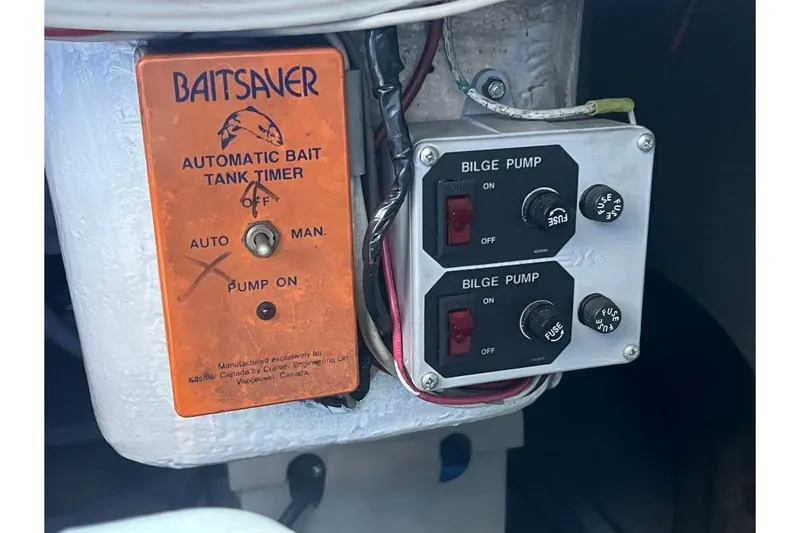 Slide: The Image of 1973 Uniflite Sport Fisher controls: Baitsaver automatic bait tank timer and bilge pump switches. - 135