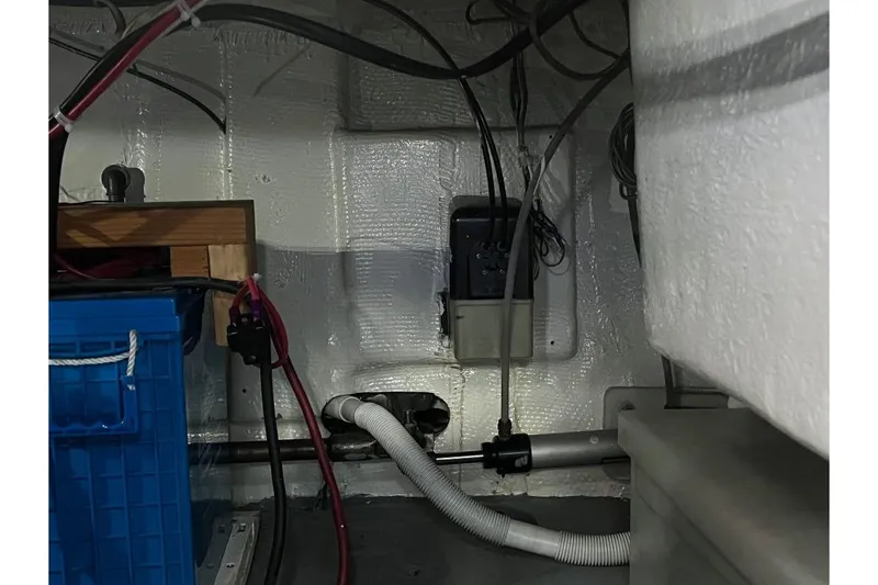 Slide: The Image of 1973 Uniflite Sport Fisher interior wiring and components, featuring cables and storage. - 136