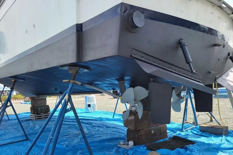 Slide: The Image of 1973 Uniflite Sport Fisher boat on stands, showing propellers and hull maintenance. - 139