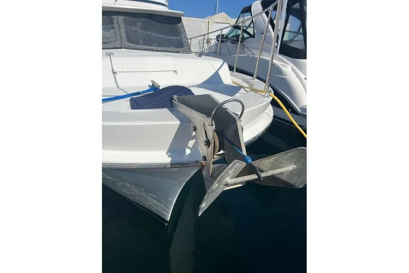 Slide: The Image of 1973 Uniflite Sport Fisher boat with anchor, docked in marina. - 16