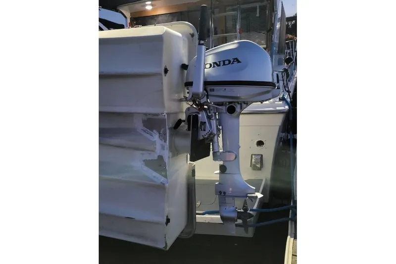 Slide: The Image of 1973 Uniflite Sport Fisher boat with Honda outboard motor attached. - 19