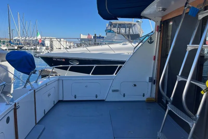 Slide: The Image of 1973 Uniflite Sport Fisher boat docked at marina with clear blue sky. - 21