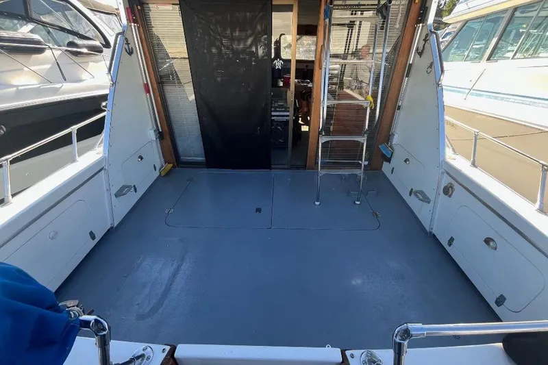 Slide: The Image of 1973 Uniflite Sport Fisher boat deck with open cabin entrance and ladder. - 22