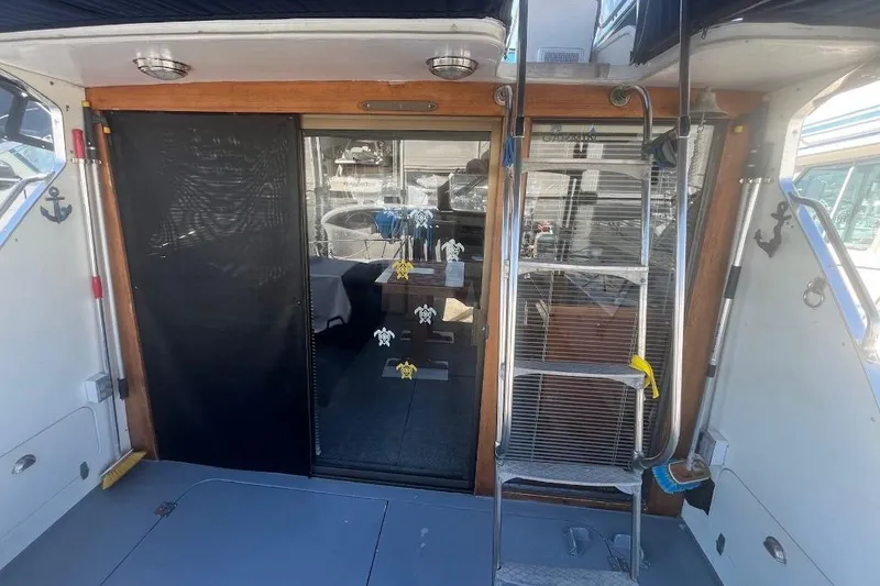 Slide: The Image of 1973 Uniflite Sport Fisher boat interior with ladder and sliding glass door. - 23