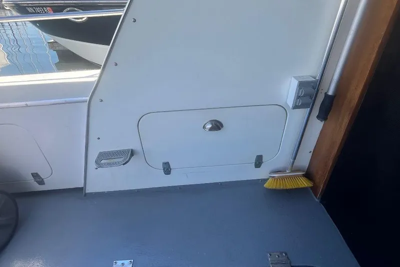 Slide: The Image of 1973 Uniflite Sport Fisher interior with storage compartment and broom. - 30