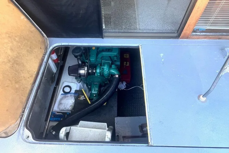 Slide: The Image of 1973 Uniflite Sport Fisher engine compartment with visible machinery and tools. - 33