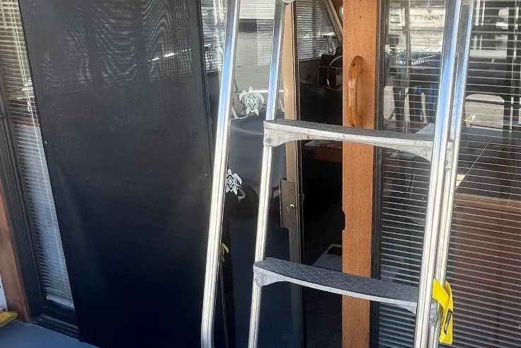 Slide: The Image of 1973 Uniflite Sport Fisher boat interior with ladder and wooden accents. - 34