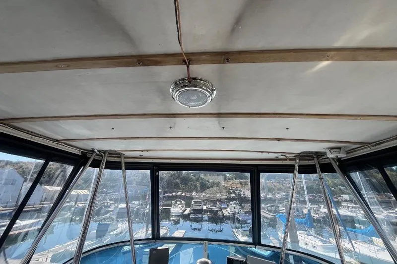 Slide: The Image of Interior view of 1973 Uniflite Sport Fisher boat with marina in background. - 37