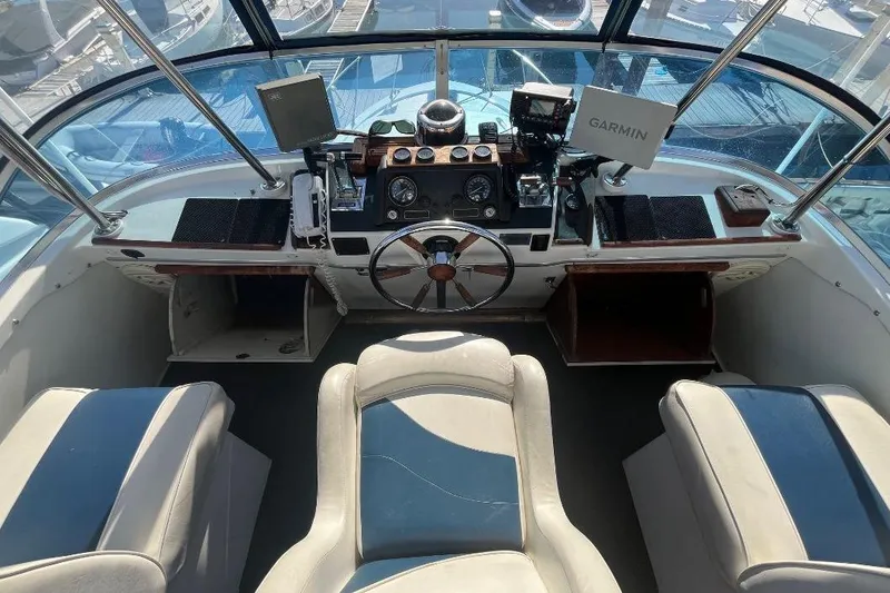 Slide: The Image of 1973 Uniflite Sport Fisher boat cockpit with steering wheel and navigation equipment. - 39