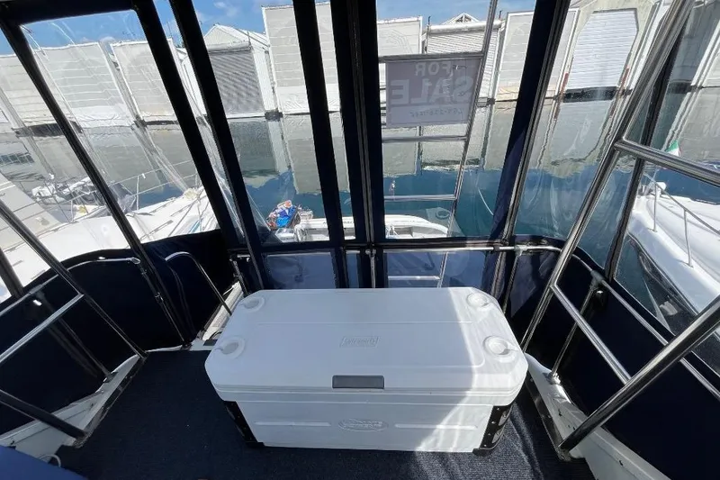 Slide: The Image of 1973 Uniflite Sport Fisher boat interior with cooler, docked at marina. - 46