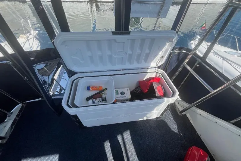 Slide: The Image of 1973 Uniflite Sport Fisher boat interior with open cooler and various items inside. - 47