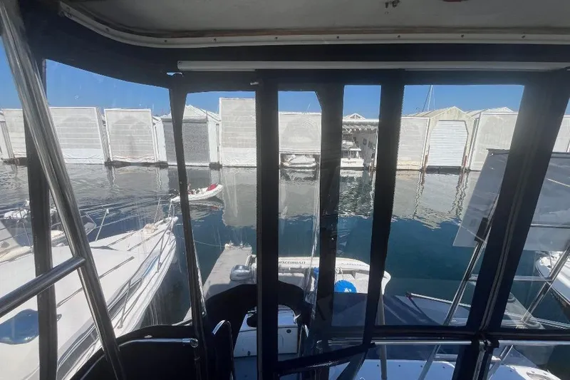 Slide: The Image of 1973 Uniflite Sport Fisher boat interior view, overlooking marina with docked boats. - 48