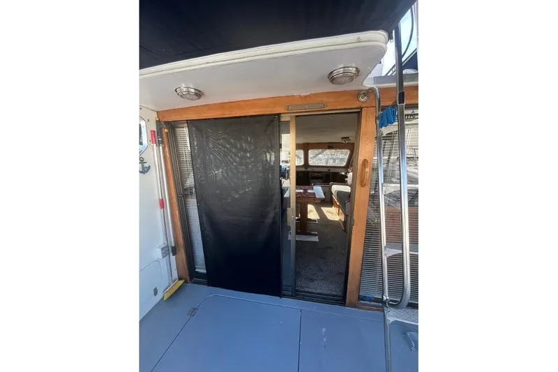 Slide: The Image of 1973 Uniflite Sport Fisher boat interior with sliding door and seating area. - 50