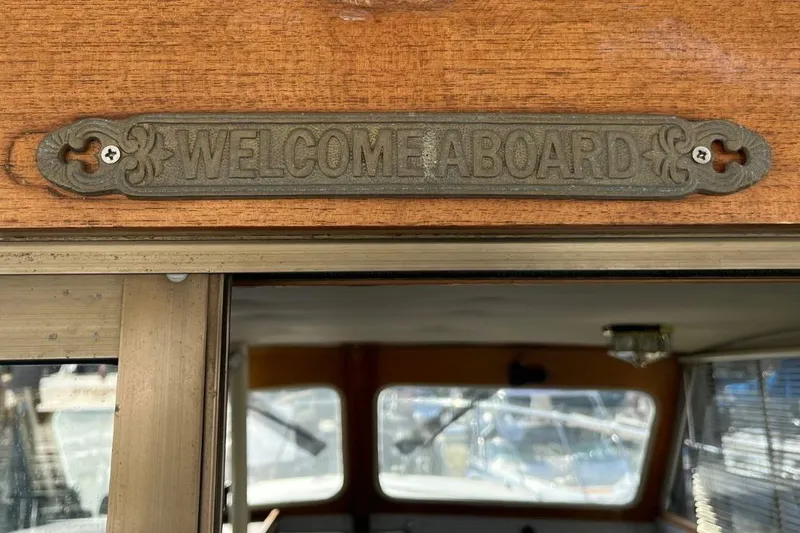 Slide: The Image of "Welcome Aboard" sign on 1973 Uniflite Sport Fisher boat interior. - 51