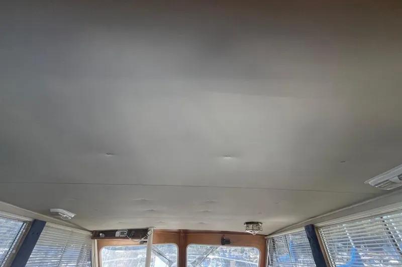 Slide: The Image of Interior ceiling of a 1973 Uniflite Sport Fisher boat with windows and blinds. - 52