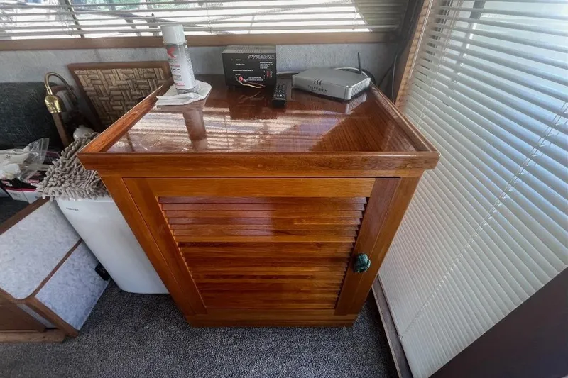 Slide: The Image of 1973 Uniflite Sport Fisher interior with wooden cabinet and electronic devices. - 55