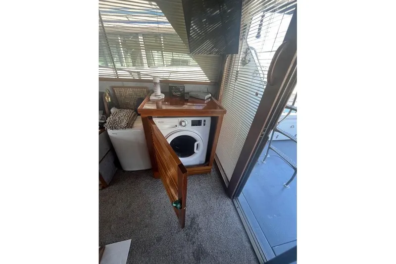Slide: The Image of 1973 Uniflite Sport Fisher interior with washing machine and wooden cabinetry. - 56
