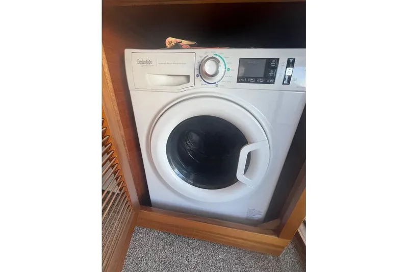 Slide: The Image of Front-loading washing machine in a wooden cabinet on a 1973 Uniflite Sport Fisher boat. - 57