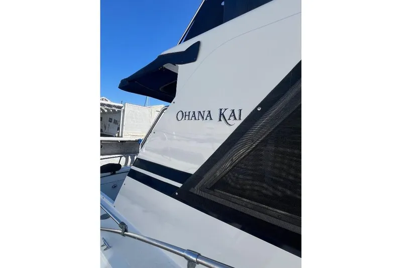 Slide: The Image of 1973 Uniflite Sport Fisher boat named "Ohana Kai" with sleek white exterior. - 6